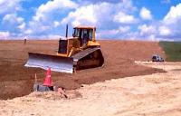 Photo of heavy equipment smoothin soil surface